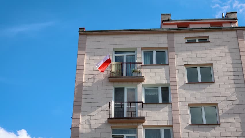 Polish flag on apartment building in Warsaw city, Poland, 4k