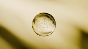 A professional macro visualization of a thick, golden liquid in a dynamic swirling motion. The shot captures realistic surface ripples, intricate air bubbles, and warm amber reflections that convey a sense of purity and premium quality. This versatile asset is ideal for luxury cosmetic advertisements, essential oil branding, nutritional supplement marketing, and high-end automotive lubricant visuals. The clean, organic flow provides a perfect background for product labels or promotional text. - Powered by Shutterstock - Get 15% off with code: PIKWIZARD15