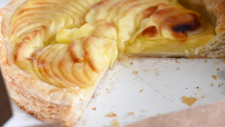 Apple pie slice being served on plate close-up