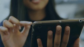 Vertical video: Woman tapping tablet and swiping, growing globe above tablet visualizing tech data. Ar, holographic, sphere, nodes, mesh, interface, device - Powered by Shutterstock - Get 15% off with code: PIKWIZARD15
