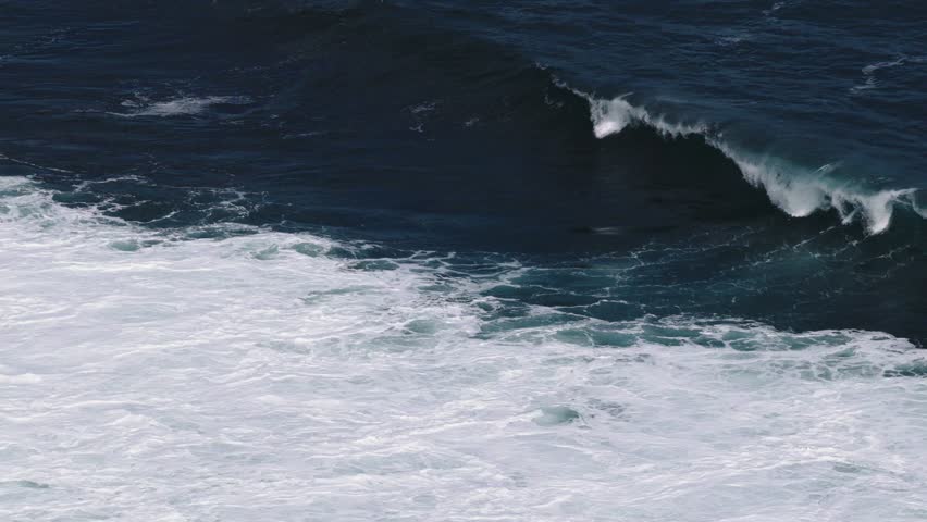 Aerial view of powerful ocean waves crashing with white foam and turquoise crests at Mesra Beach, Kecamatan Tanjungsari, Daerah Istimewa Yogya, Indonesia.