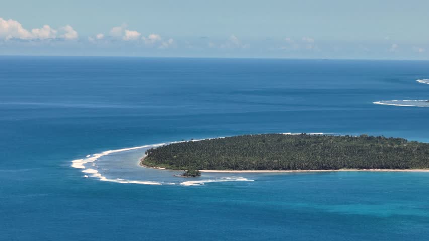 Blue sea and ocean waves in tropical island. Blue sky and cloud. Mindanao, Philippines.