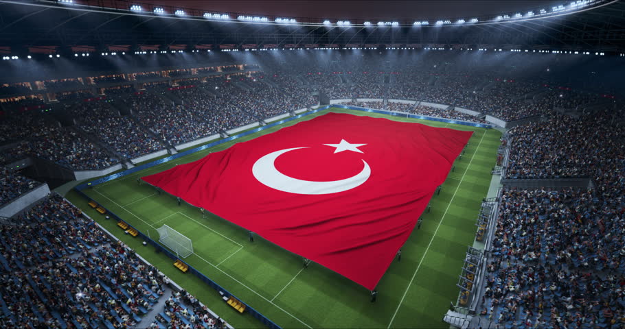 Professional Stadium With Soccer Game Championship With Flag of Turkey Spread Across Pitch Before Football Match Start. Cheering Crowds of Fans Fill the Arena During Ceremony. Aerial Static Wide Shot