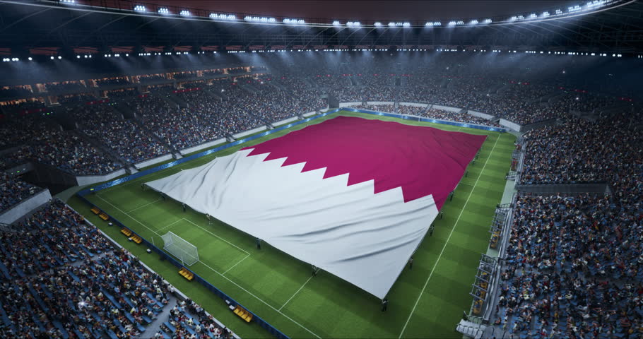 Professional Stadium With Soccer Game Championship With Flag of Qatar Spread Across Pitch Before Football Match Start. Cheering Crowds of Fans Ring the Arena in a Tense Spectacle. Aerial Static Shot