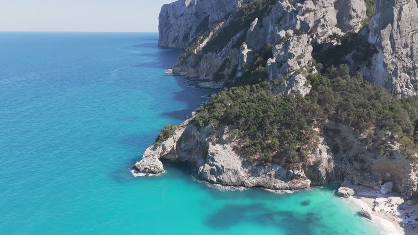 Aerial Drone Flight Above Turquoise Cove and White Sand Beach at Cala Goloritze in Sardinia Italy