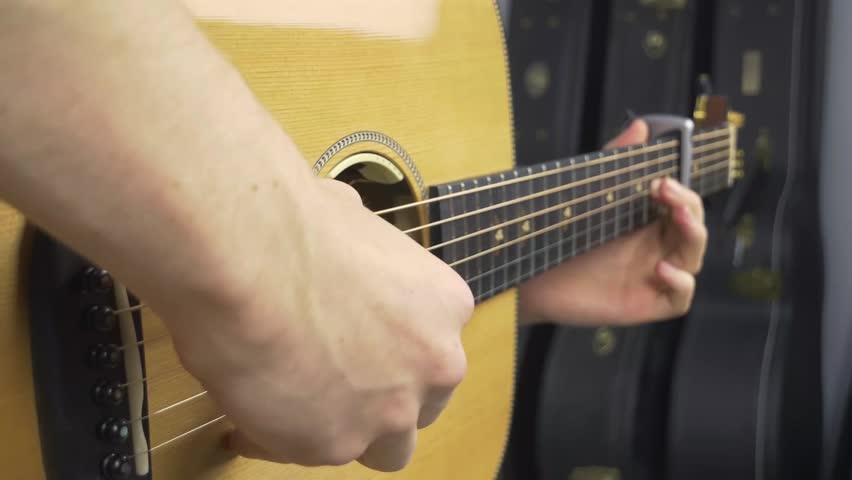 close up man playing guitar