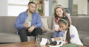 Family watching daughter drawing on tablet at table, guiding as daughter showing tablet. Family, parenting, technology, creativity, home, education, bonding - Powered by Shutterstock - Get 15% off with code: PIKWIZARD15