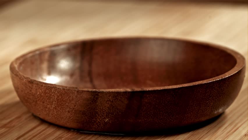 Fresh garlic falls onto a table or container. High-quality Full HD footage.