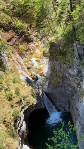 Scenic mountain gorge with waterfall and forest