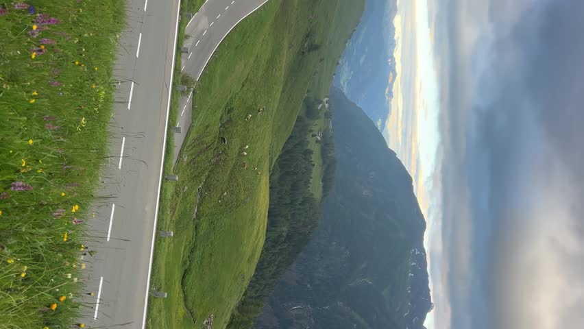 Mountain road and green valley landscape, tilted scenic travel view