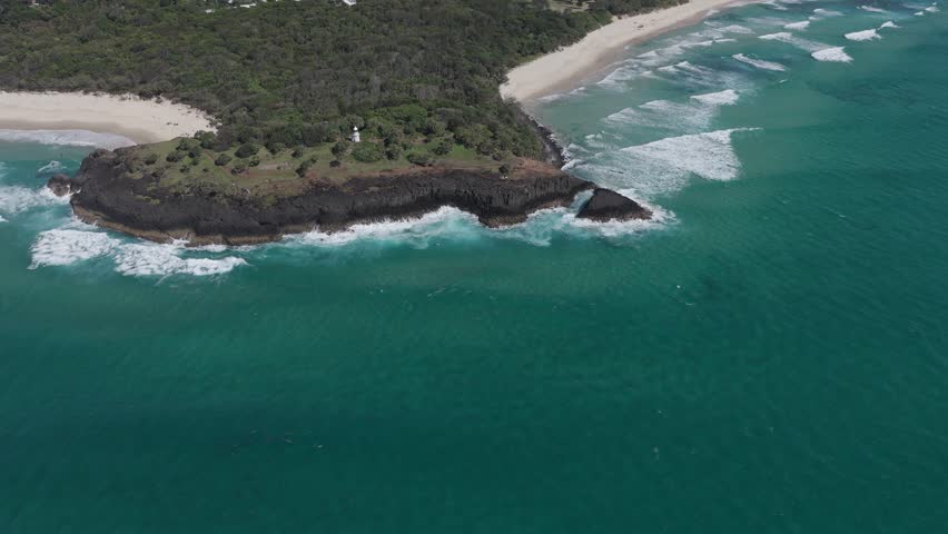 Aerial View Of Fingal Head Lighthouse On Rocky Basalt Headland In New South Wales, Australia. sideways shot