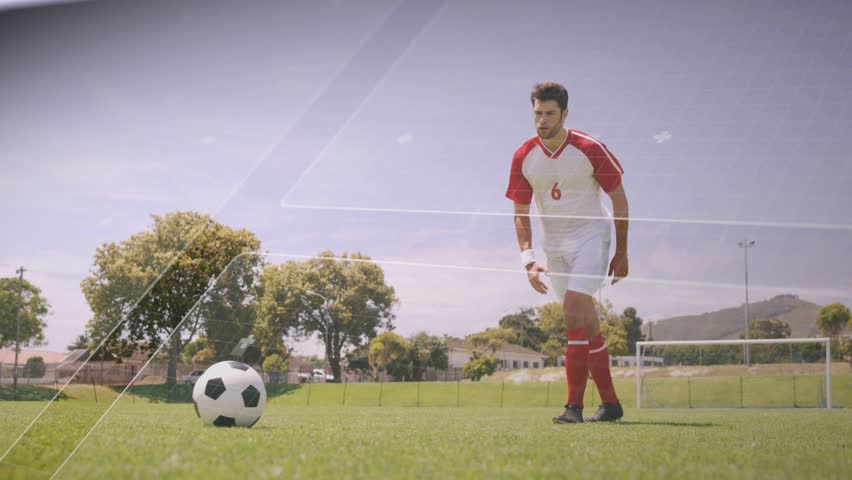 Male soccer player stepping and kicking ball on grass, white-blue overlays tracing shot toward goal. Field, athletic, football, outdoor, action, dynamic, focus