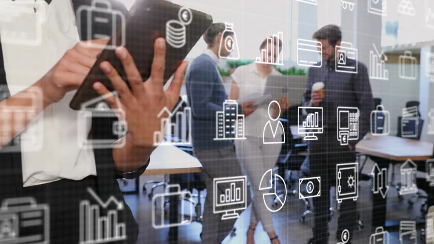 Woman tapping tablet and phone, sparking finance icons, charts, camera pulling back to team working. Office, collaboration, diverse, professional, technology, devices, openplan