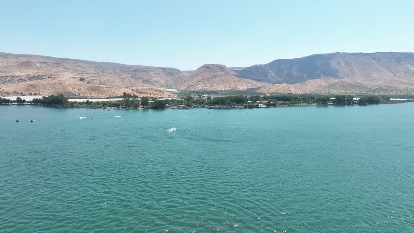 Aerial Panorama of the Sea of Galilee (Kinneret) Shoreline Featuring Resorts, Green Water, and Arid Mountains