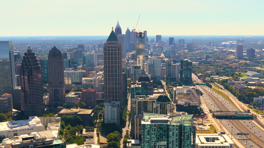 Atlanta, Georgia skyline with prominent skyscraper buildings and roads stretching across the city. Modern urban infrastructure.