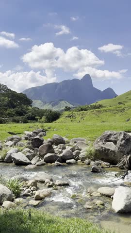 Scenic Mountain Landscape with Flowing Creek and Lush Green Valley