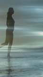 Vertical video: Woman walking shore lifting leg and kicking, splashing under light bands for ads. Silhouette, beach, sea, motion, horizon, water, vertical video - Powered by Shutterstock - Get 15% off with code: PIKWIZARD15