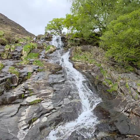 Beautiful waterfalls in Wales forest, lush green nature landscape