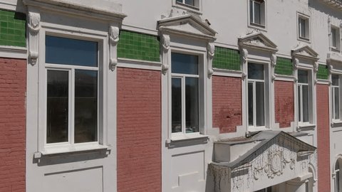 Drone Flying Sideways near Building Entrance Facade