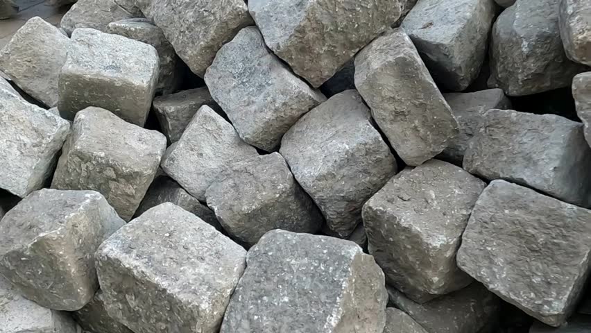 A pile of worn, used cobblestones from years ago.