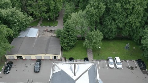 Drone Flying Backward above Administration Building Roof