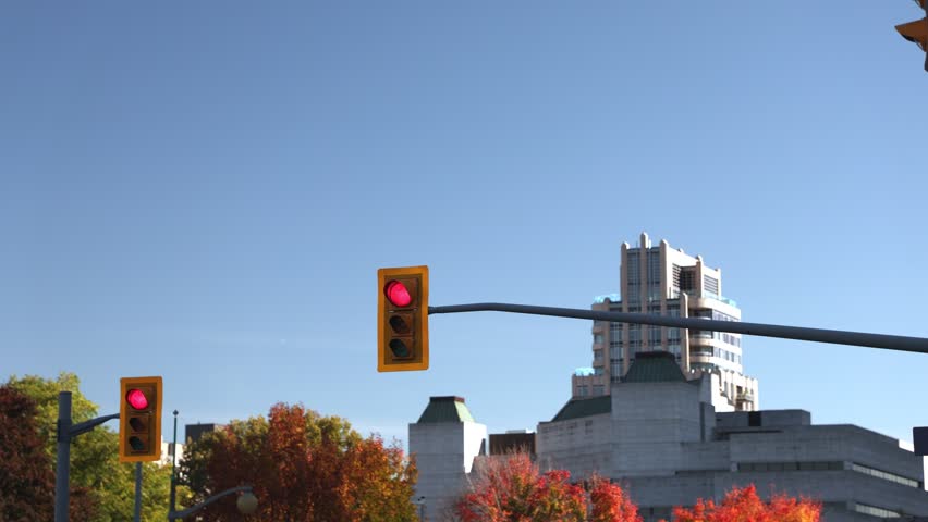 Urban intersection with red traffic lights with autumn foliage in Ottawa