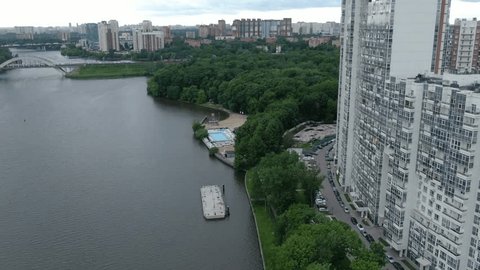 Drone Moving above River Urban Skyline