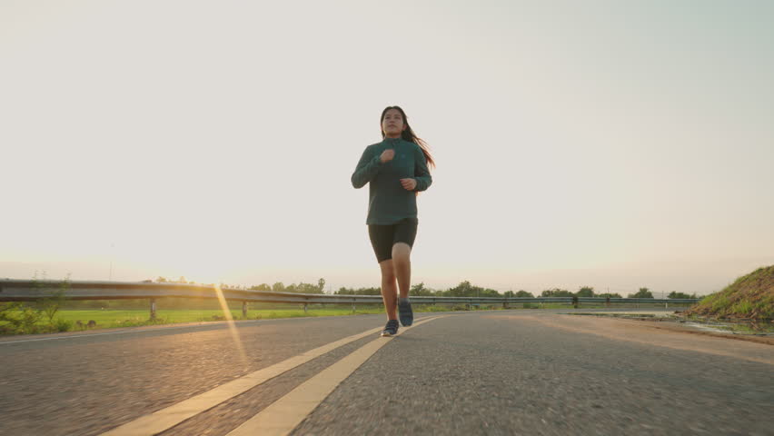 Teenage Girls running in country road.
