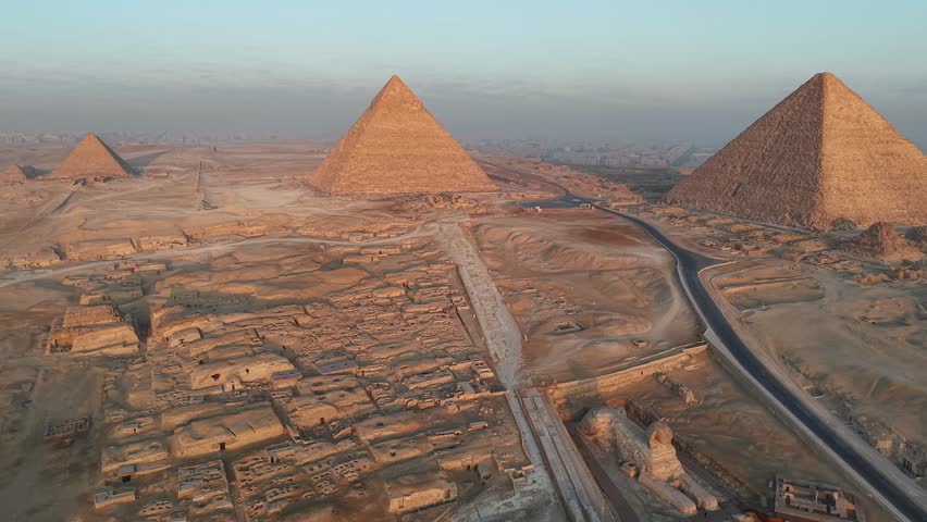 Panorama drone shoot of pyramids of Giza and sphinx at sunrise time - Egypt