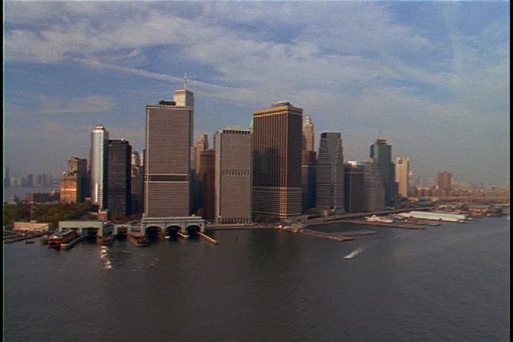 Aerial shot circling Lower Manhattan. Confluence of East and Hudson Rivers in foreground in New York City, USA.