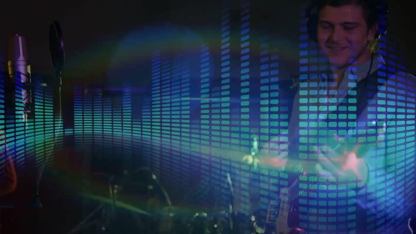 Vertical video: Male singer adjusting grip, strumming, singing in studio for duet EQ overlay moving. Microphone, guitar, tambourine, headphones, recording, equalizer, lensflare