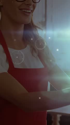 woman in red apron and glasses reaching cafe counter activating HUD overlaying face showing menu. Kitchen, cook, adult, smile, intimate, cozy, vertical video
