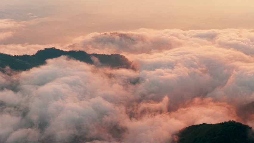 Aerial view above the sea of ​​clouds with the sunset