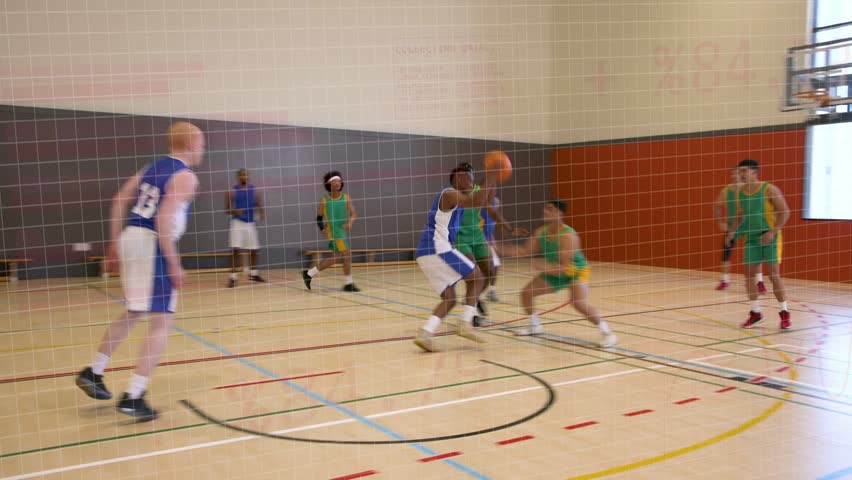 Basketball play showing green player driving and shooting, ball on rim, defense scrambling for ball. Court, gymnasium, rebound, athletes, intensity, benches, daylight