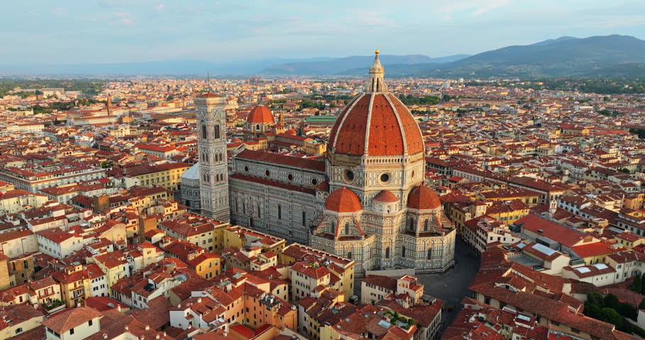 Panoramic cityscape Florence Italy aerial. Iconic Duomo cathedral medieval architecture red roofs sunny summer day. Tuscan travel destination exploration UNESCO heritage site landmark high angle view.