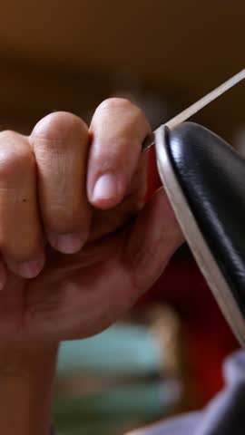 Shoemaker repairing a shoe in workshop 4k