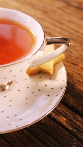 Cup of coffee with cookies on wooden table 4k
