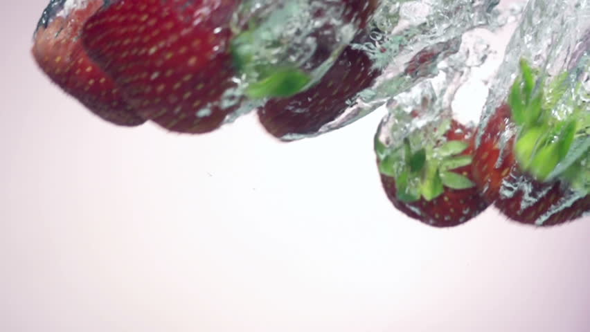 Fresh strawberry under water with a splash.