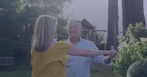 Mature couple twirling in garden as AR badges appearing over them, showing social media reach. Senior, pair, outdoor, backyard, lawn, dance, joy - Powered by Shutterstock - Get 15% off with code: PIKWIZARD15