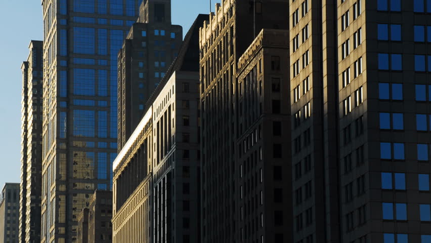 Sun rises on buildings in city time lapse