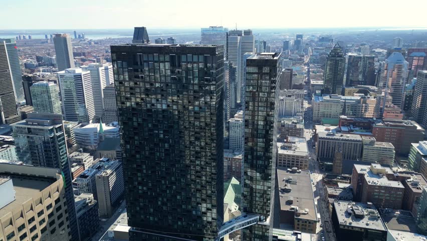 Aerial view of downtown Montreal cityscape with modern buildings and urban streets in Quebec, Canada. Daytime skyline featuring residential and commercial architecture. Ideal for business, real estate and urban lifestyle concepts.