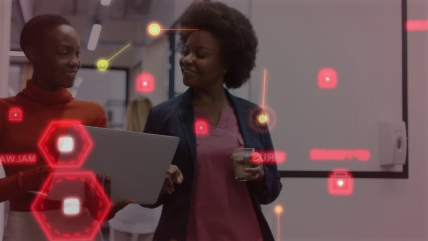 Two women walking hall, one opening laptop starting AR hex, other with cup reviewing business data. Colleagues, collaboration, augmented, reality, office, corridor, technology
