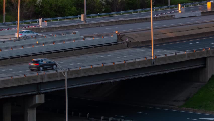 Washiongton DC. Aerial view of a multilane highway during the evening, with a car driving on the right side of the frame.