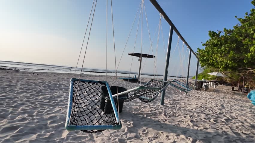 A serene beach scene with a volleyball net in the sand video