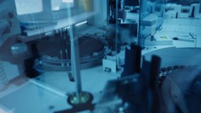 Slow motion robotic pipette dispensing sample vials in clinical laboratory benchtop analyzer during automated processing. - Powered by Shutterstock - Get 15% off with code: PIKWIZARD15