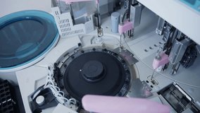 Blood tester, analyzer rotor spinning and pipette dispensing samples on clinical laboratory bench. - Powered by Shutterstock - Get 15% off with code: PIKWIZARD15