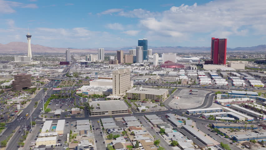 Aerial pullback shot of Las Vegas Strip hotels and city streets