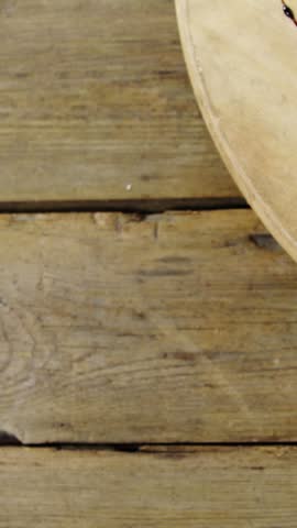 Overhead view of meat and salad on wooden plate