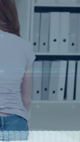woman standing by binders while hand entering placing health clip for monitoring and HUD animating. Sensor, office, archive, files, shelving, back, vertical video