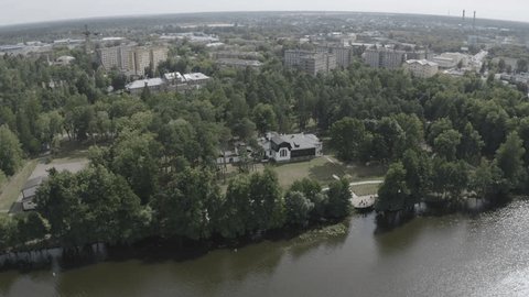 Drone Flying above River near Forest Town